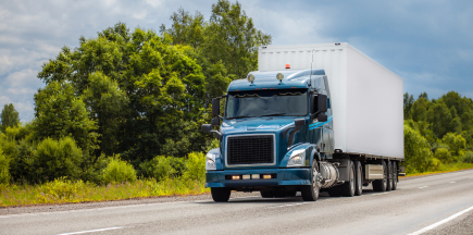 Business employees reviewing documents in a commercial vehicle, explaining the need for commercial auto insurance.